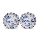 Pair of 18th century Dutch Delft plates, the centre painted in Chinese porcelain Kangxi style with
