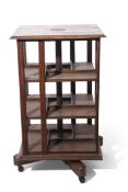 Goodall Lamb & Highway Ltd of Manchester, early 20th century revolving oak bookcase, a metal