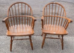 Pair of light oak stick back solid seat armchairs