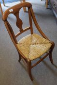 Small stained wood rush seated child's chair with vase shaped splat back