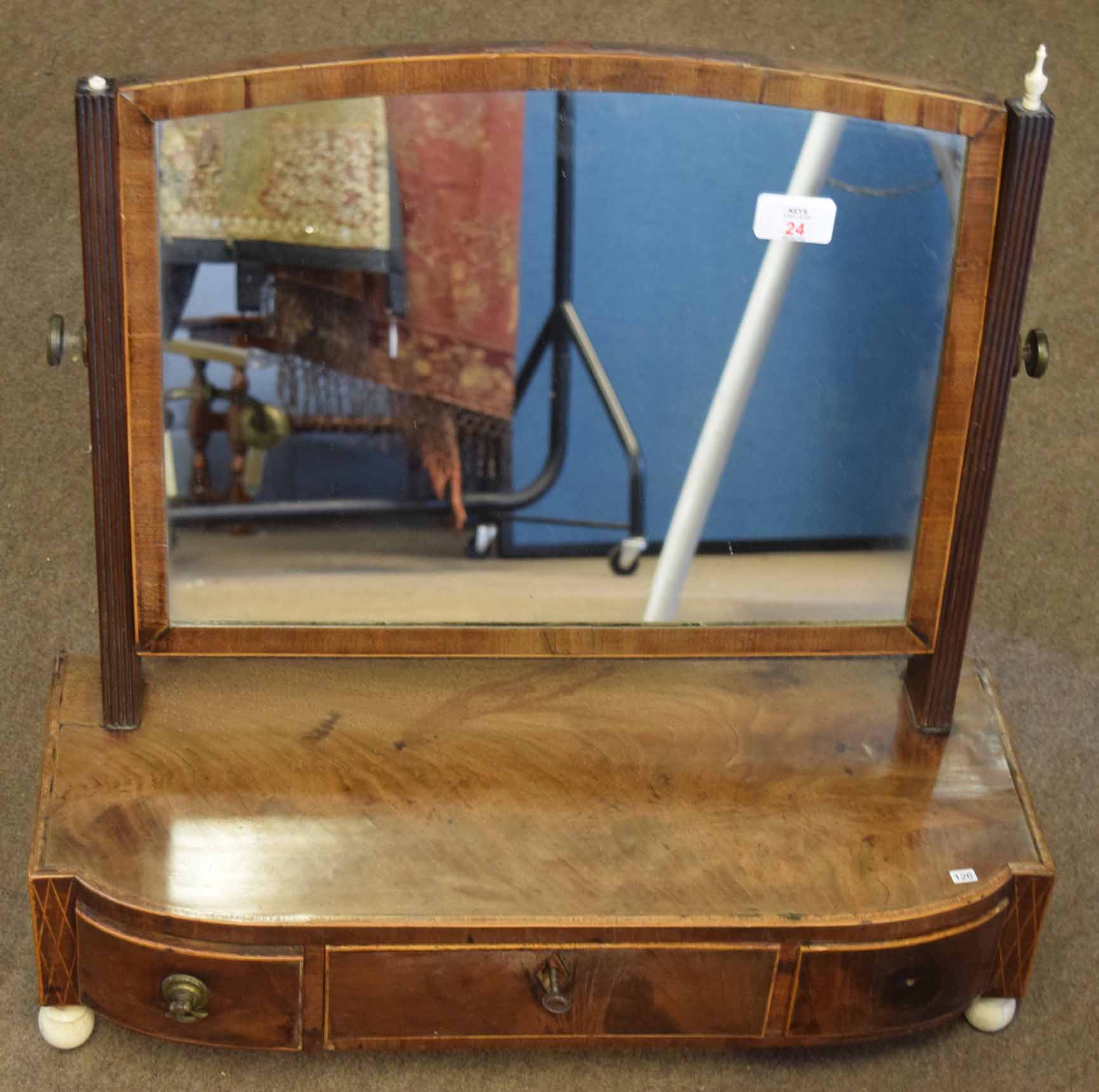 Early 19th century mahogany toilet mirror with ivory finials and similar ball feet, bowed base