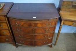 Mahogany bow front chest of four full width graduated drawers with brushing slide, splayed feet,