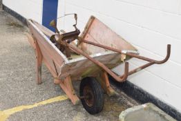 Large vintage wheelbarrow with metal bound rim, together with a vintage hoe, 90cm wide