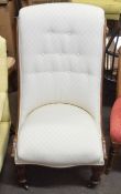 Victorian mahogany nursing chair upholstered in cream, button back