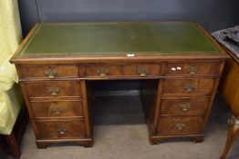 Early 20th century mahogany twin pedestal desk with gilt tooled leather inset over three frieze