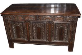 18th century polished and carved oak coffer having three arched carved panels below a lunette