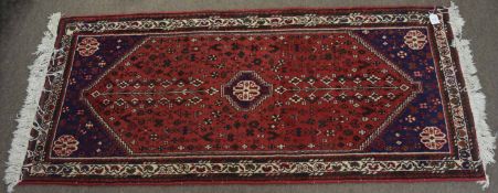 Late 20th century Caucasian style small rug, triple gull border, central large lozenge, red, blue,