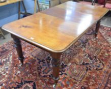 Victorian mahogany extending dining table with moulded edge raised on ring turned tapering