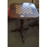 Victorian mahogany pedestal games table with chequerboard inset, raised on a ring turned stem and