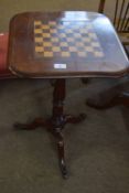 Victorian mahogany pedestal games table with chequerboard inset, raised on a ring turned stem and