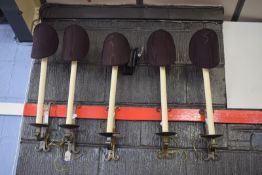 Set of four late 20th century wrought iron wall lights in Baronial style, having riveted and spot