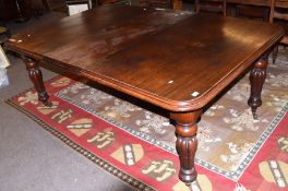 Mid-Victorian mahogany extending dining table of rounded-end rectangular form and inset with one