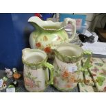 THREE FLORAL JUGS INCLUDING LARGE WATER JUG BY MAPLE, LARGEST APPROX 29CM