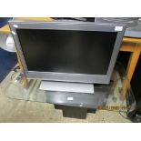 SONY 26” FLAT SCREEN TV TOGETHER WITH GLASS TOPPED STAND