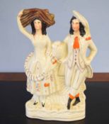 Staffordshire pottery flatback of a couple, decorated in typical fashion