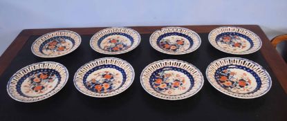 Group of eight Japanese porcelain Imari style plates with pierced rims (8)