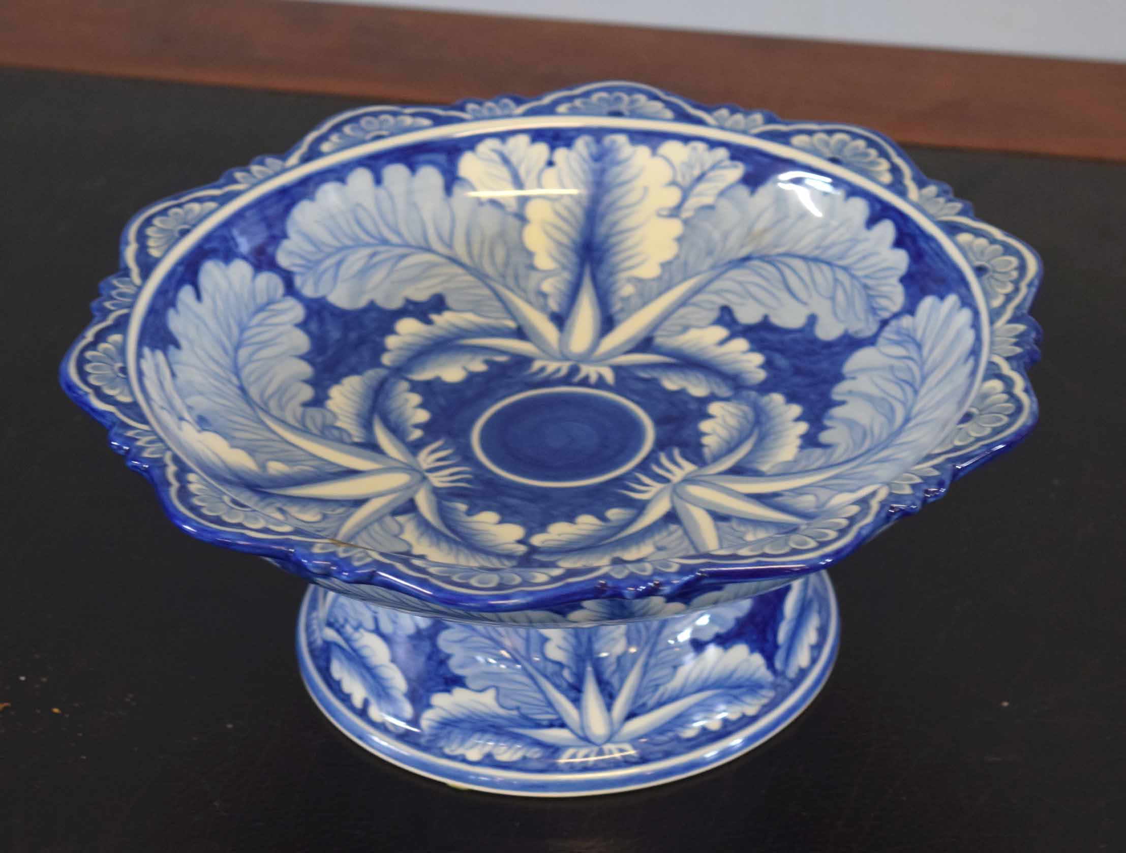 Pottery tazza decorated in a flow blue design with flowers