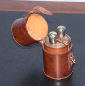 Vintage leather case with two D-shaped glass spirit flasks, each with hallmarked silver covers, 12cm