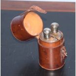 Vintage leather case with two D-shaped glass spirit flasks, each with hallmarked silver covers, 12cm