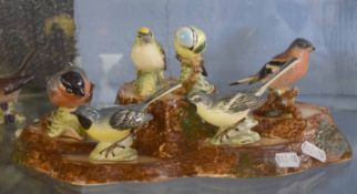 Collection of Beswick bird models mounted on a wooden effect tree stump (6)