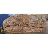 Large tribal wooden carved story board of a village scene, decorated with tribesman in canoes,