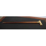 Malacca cane applied with a bone or ivorine handle formed as a temple dog with a ball in its