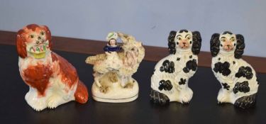 Group of three Staffordshire dogs and a further Staffordshire figure of a girl mounted on a goat