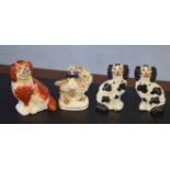 Group of three Staffordshire dogs and a further Staffordshire figure of a girl mounted on a goat