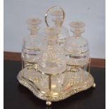 Silver plated set containing four small cut glass decanters with mushroom shaped stoppers (4),