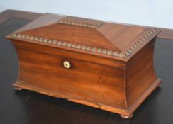 Large mahogany sarcophagus shaped tea caddy with two compartments and central bowl, 34cm wide