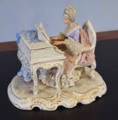 Large Continental porcelain group of a lady seated playing the piano on scroll base