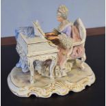 Large Continental porcelain group of a lady seated playing the piano on scroll base