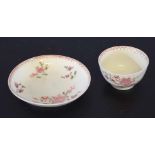 18th century Lowestoft porcelain tea bowl and saucer decorated with a floral design