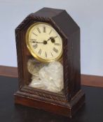 Small oak cased mantel clock with circular Roman chapter ring