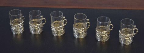 Collection of six small liquor or shot glasses in silver frames, the silver hallmarked for