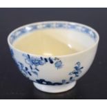 Lowestoft 18th century tea bowl with a blue and white floral and root pattern, the interior with