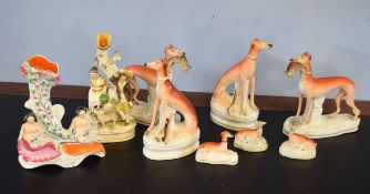 Group of Staffordshire wares including a number of greyhound models, two with hares in mouths, and