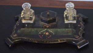 Lacquered papier mache ink stand fitted with two bottles, central compartment and pen tray, 32cm