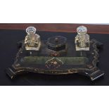 Lacquered papier mache ink stand fitted with two bottles, central compartment and pen tray, 32cm