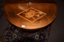 19th century mahogany fold-top card table of demi-lune form, the lid inlaid with a central panel