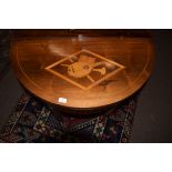 19th century mahogany fold-top card table of demi-lune form, the lid inlaid with a central panel