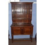 Oak dresser, plate rack back with three shelves fitted with hooks, the base with two panelled