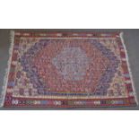 Wool embroidered Caucasian type carpet, central panel with pale blue lozenge and further red, blue