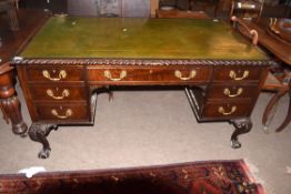 Early 20th century mahogany partner's desk, gilt tooled green leather inset fitted on one side