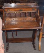 Oak bureau with tambour shutter front enclosing pigeonholes and drawers, raised on platform type