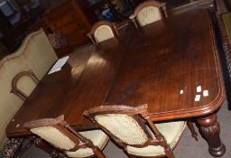 Mid-Victorian mahogany extending dining table of rounded-end rectangular form and inset with one