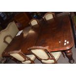 Mid-Victorian mahogany extending dining table of rounded-end rectangular form and inset with one