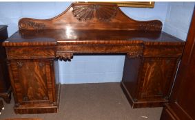 Large 19th century mahogany twin pedestal break front sideboard, pediment carved with foliate