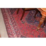 Large Caucasian carpet, central blue lozenge, mainly red and black field, 3.1 x 2.26m
