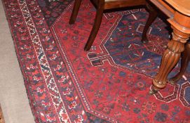 Large Caucasian carpet, central blue lozenge, mainly red and black field, 3.1 x 2.26m